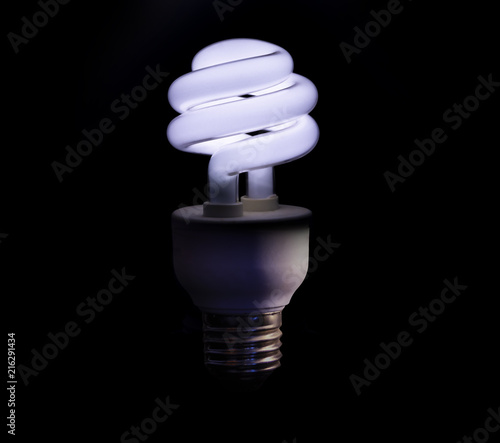 Cold white lightbult on on a black background
