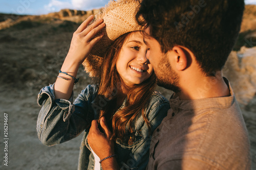 young smiling couple embracing and looking at each other
