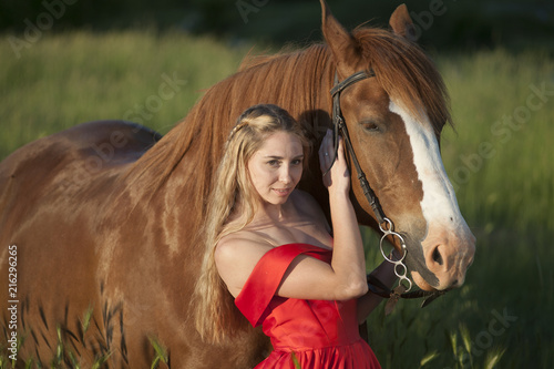 girl in a red dress with a horse