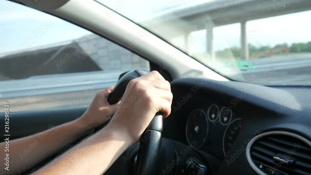 Man drives the car holding hands on the steering wheel on autobahn highway Man drives the car holding hands on the steering wheel on autobahn highway