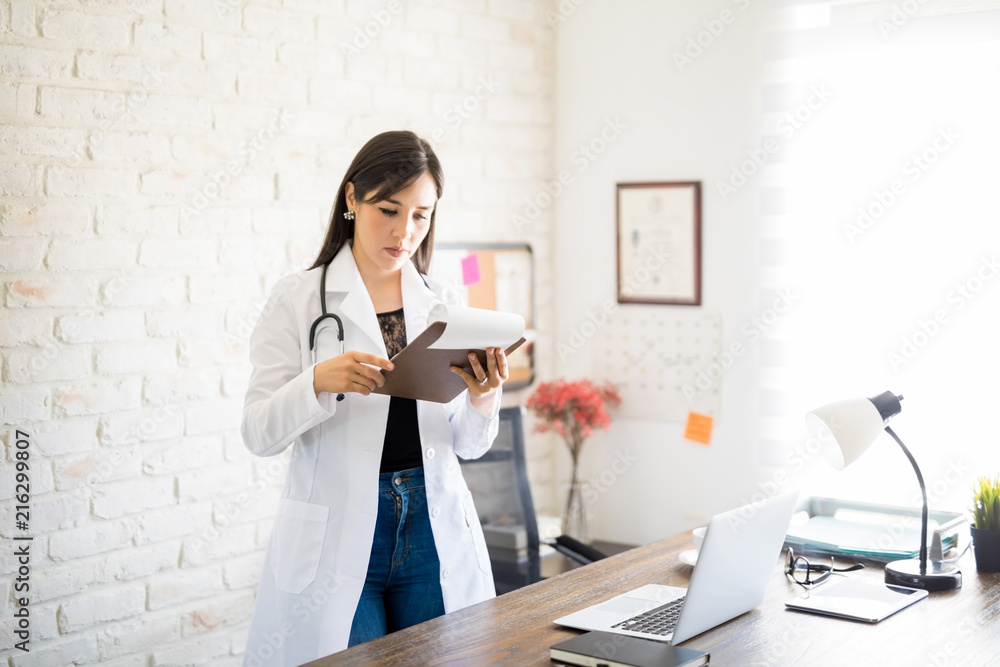 Physician examining the patient's reports Physician examining the patient's reports