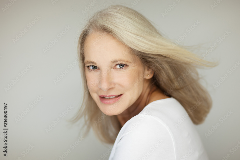 stunning beautiful and self confident best aged woman with grey hair smiling into camera, portrait with white background stunning beautiful and self confident best aged woman with grey hair smiling into camera, portrait with white background
