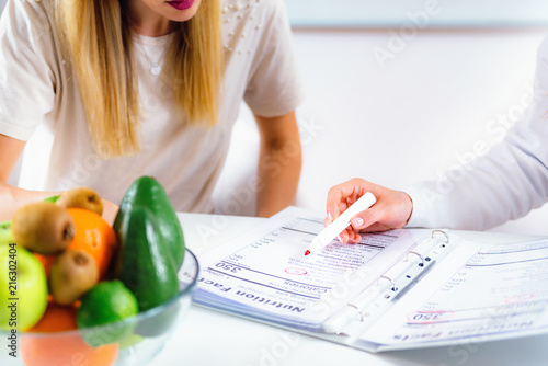 Nutritionist with female patient photo