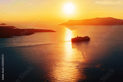 Silhouette of a cruise ship in sunset light © maxpetrov