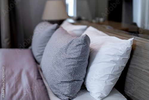 light soft pillow on beautiful bed cozy bedroom with sun light from window interior concept © whyframeshot