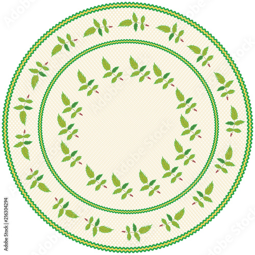 Round serviette with abstract embroidery with leafs in green,yellow colors on weave beige backdrop with  fringe