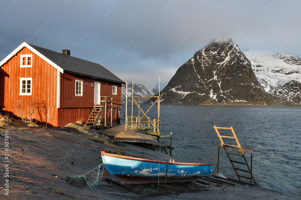 A Rorbu on the coast near Sakrisoy on the Lofoten islands, Norway, looking towards mount Olstind