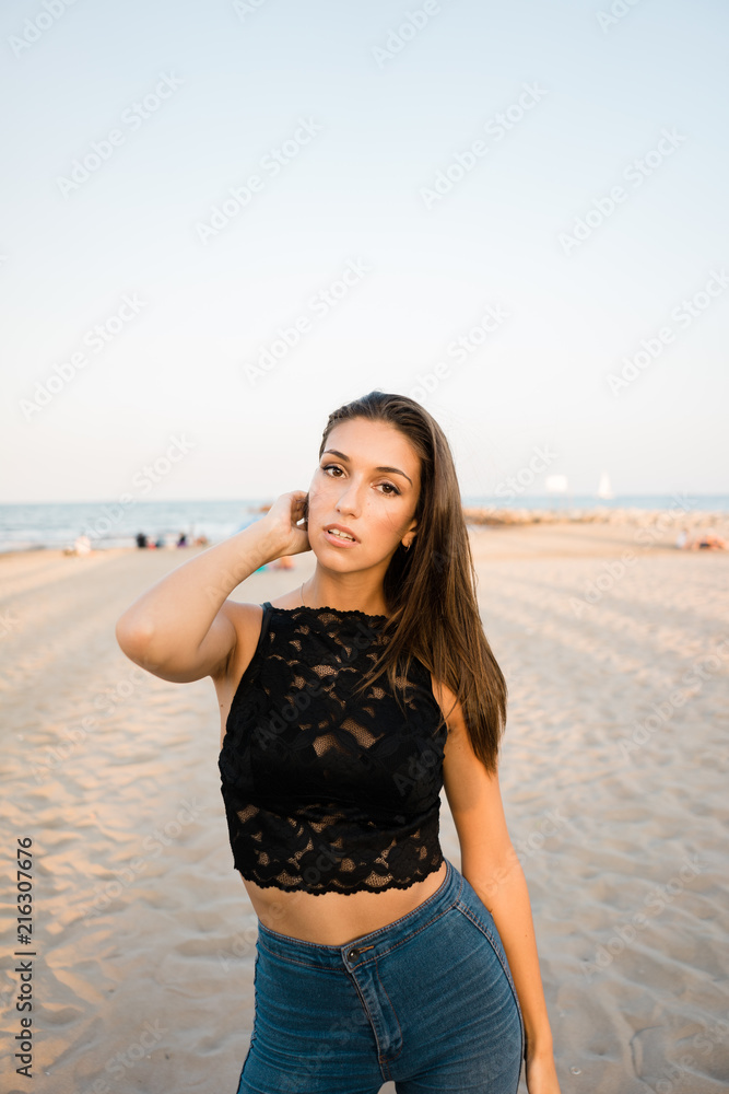 Gorgeous brunette woman posing on beach Gorgeous brunette woman posing on beach
