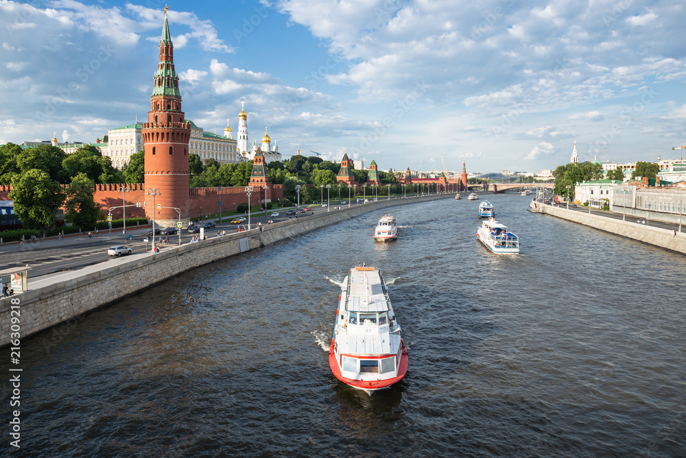 View of the river Moscow with walking ship, Kremlevskaya Embankment and towers of the Moscow Kremlin