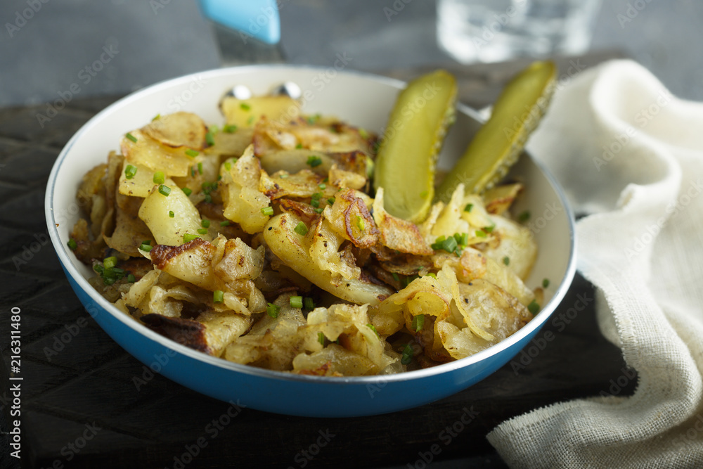 Fried potato with pickled cucumber