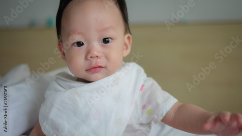 The Asian shy boy have a cold with having a runny nose.