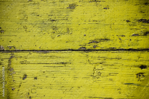 Bright background of horizontal of green yellow wooden boards. Abstract acid color closeup shot of old country fence