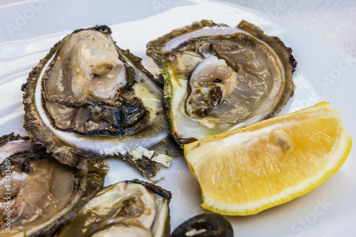 Oyster and lemon on the white plate