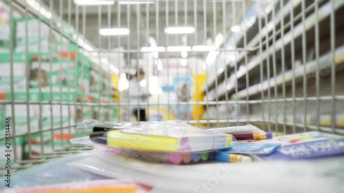 shopping wagon cart moving through store. Purchase of stationery for school.