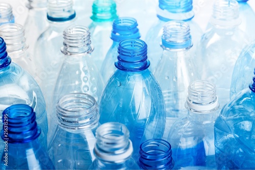 Plastic bottles of water on background