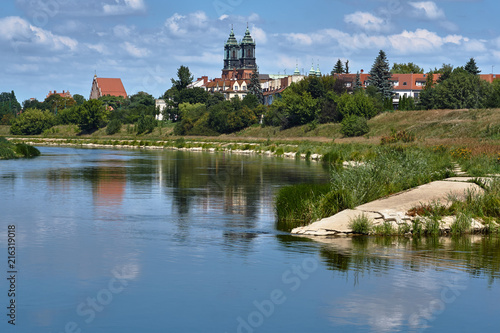 Urban landscape with river Warta and the cathedral towers in Poznan.