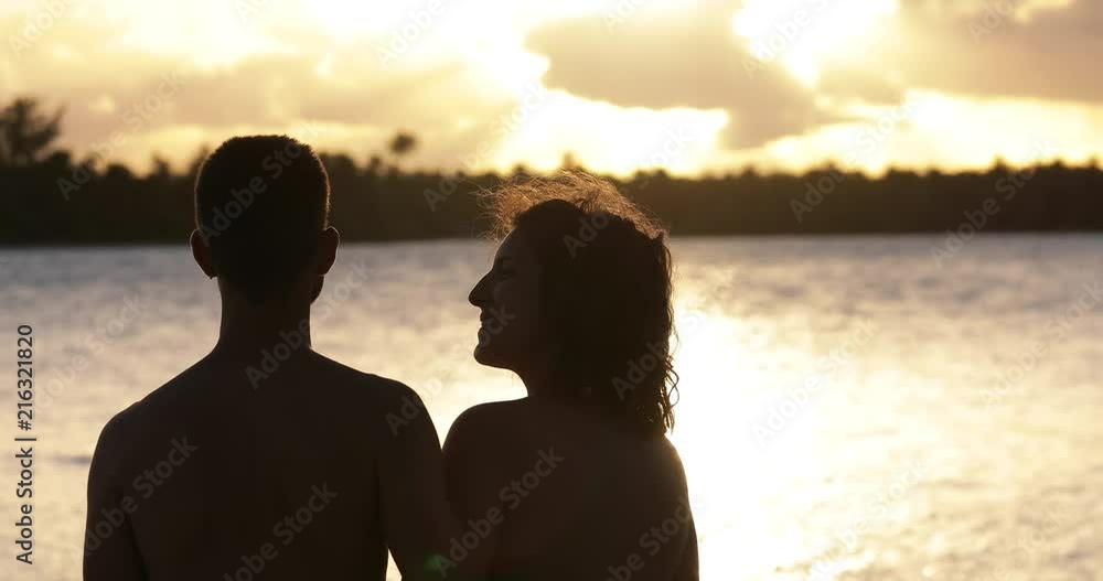a couple on the beach with sunset a couple on the beach with sunset