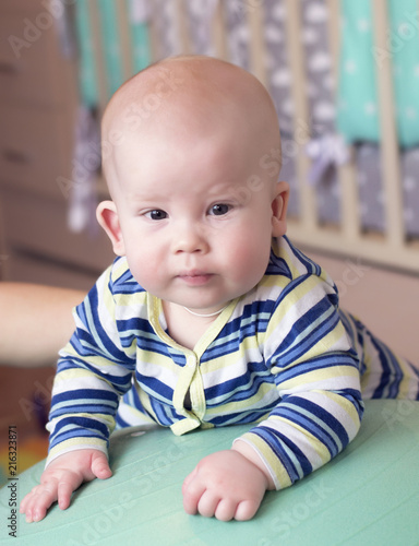 The child is lying on a rubber ball