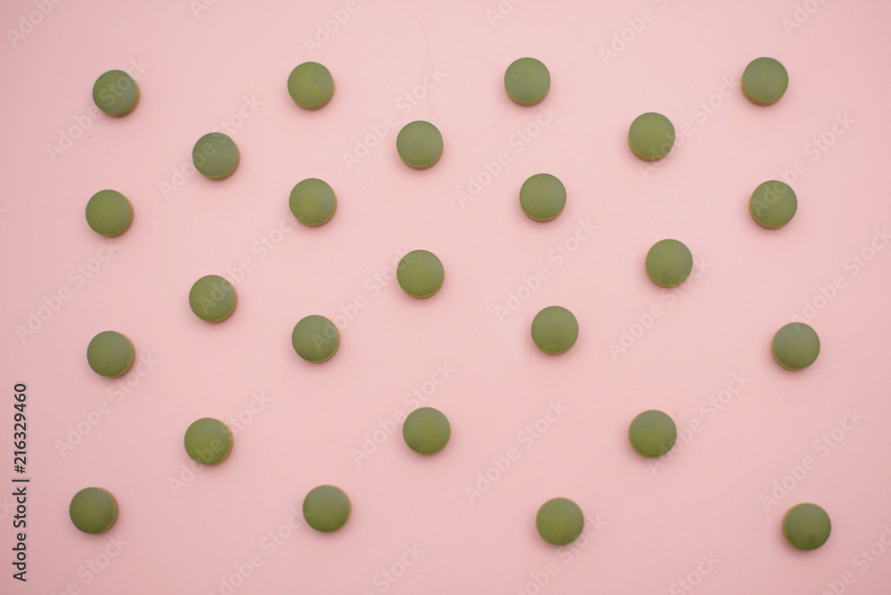 chlorella tablets on pink background chlorella tablets on pink background