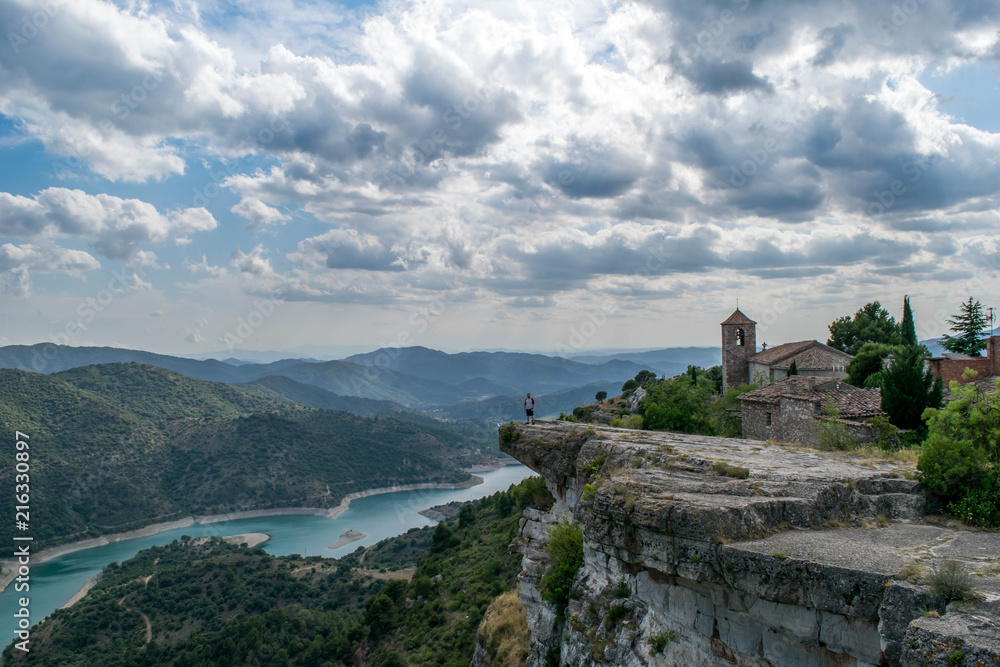 Man standing on a cliff-top in Siurana, Spain