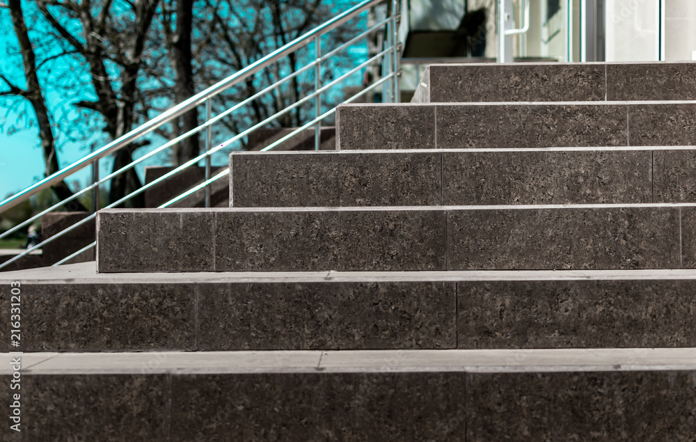 Stone granite stairs steps background with metallic aluminium handle. Red  brown modern stairs. Entrance to the shop in the city street on blue sky  and trees background. Stock Photo | Adobe Stock