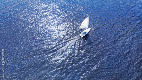 Photos Aerial. Nautical sailling of a catboat yacht.