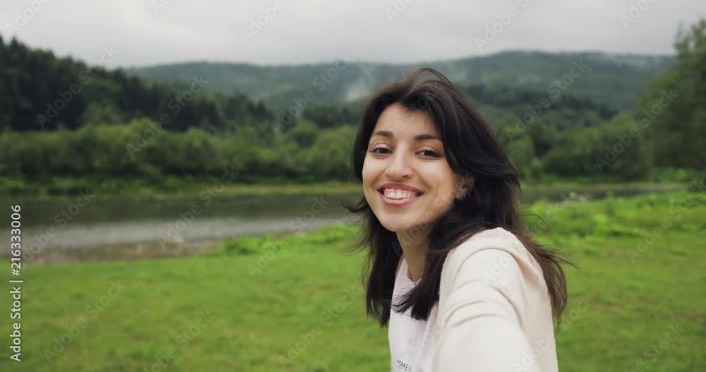 Brunette young women make stories, selfie in the mountains near the river Showing landscapes. Impressed, happy. Brunette young women make stories, selfie in the mountains near the river Showing landscapes. Impressed, happy.