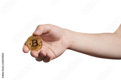 Hand holding a golden bitcoin, isolated on white background