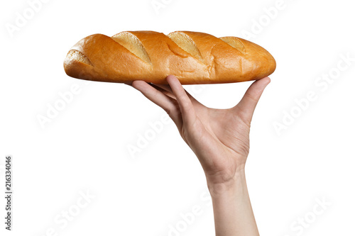 Hand carrying a fresh loaf of bread, isolated on white background photo