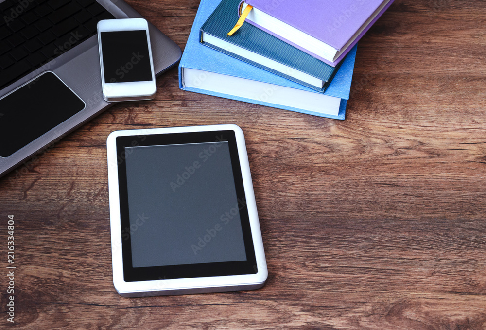 electronic book and books paper, phone and laptop on a wooden table, electronic book and books paper, phone and laptop on a wooden table,