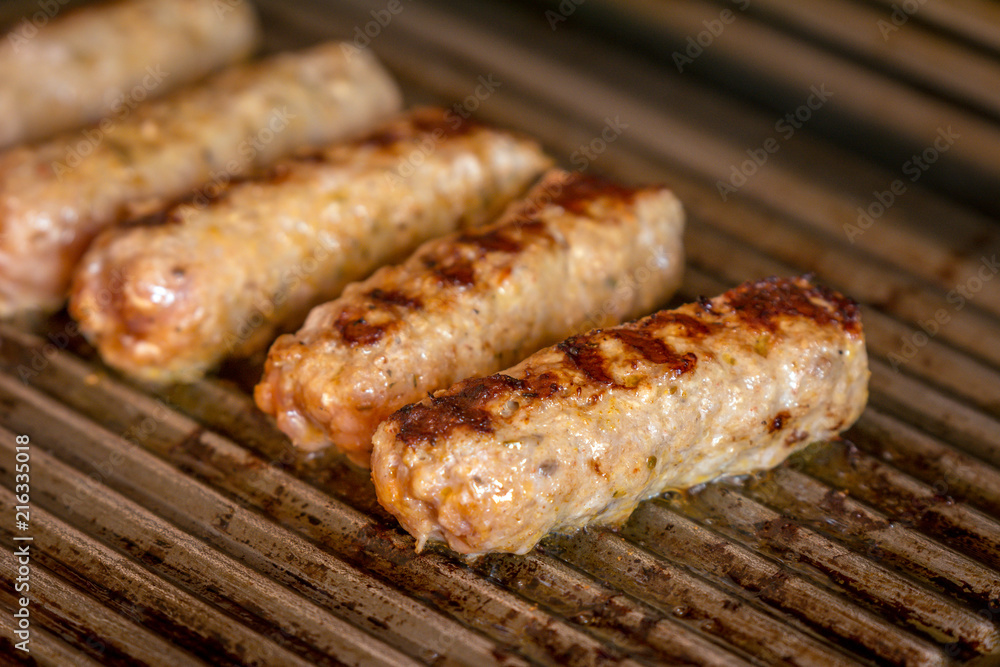 Cevapcici baked on the grill. Small sausages from minced meat, a very popular dish in the Balkan countries.