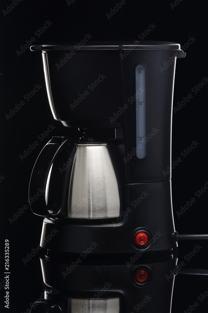 Coffee machine with pot on the black mirror background Coffee machine with pot on the black mirror background