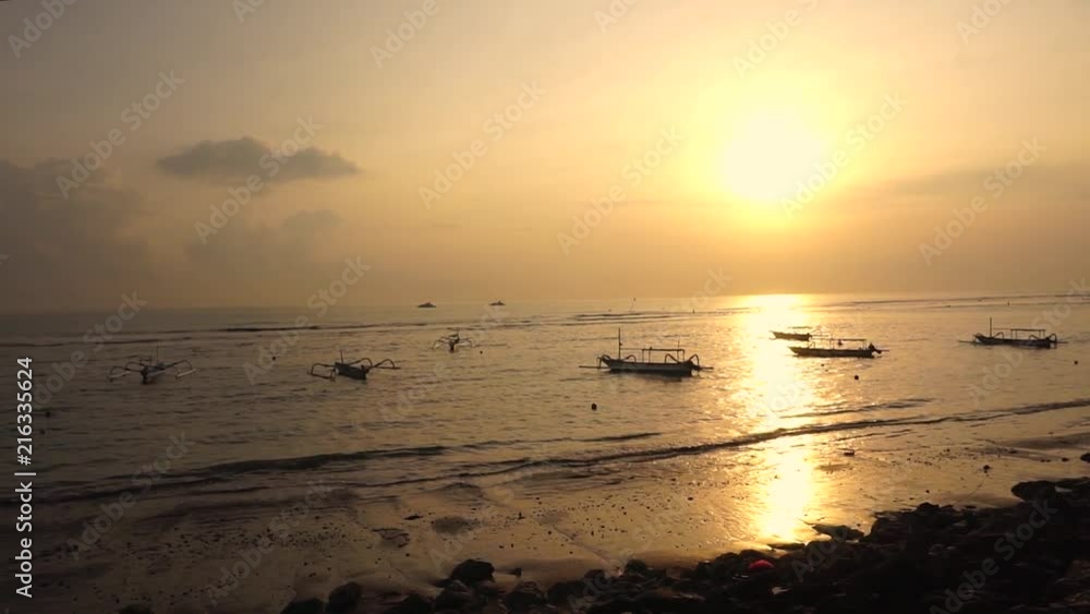 beautiful sunsets on the coast and fishing boats slammed by gentle waves, pan left wide shot slow motion beautiful sunsets on the coast and fishing boats slammed by gentle waves, pan left wide shot slow motion