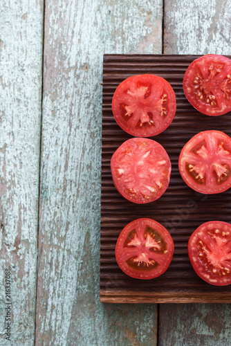Organic food. Homegrown heirloom tomatoes cut on oak board