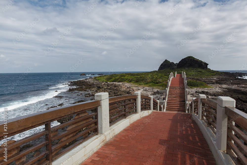 Taitung, Taiwan - Three Saints Island Pedestrian Bridge, Pacific Coast. Seascape Background Image. View from top of pedestrian bridge, ocean waves and island in the background