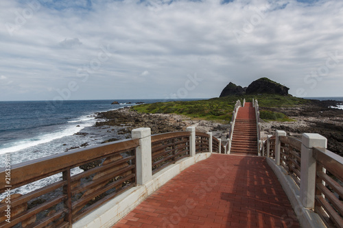 Taitung, Taiwan - Three Saints Island Pedestrian Bridge, Pacific Coast. Seascape Background Image. View from top of pedestrian bridge, ocean waves and island in the background photo