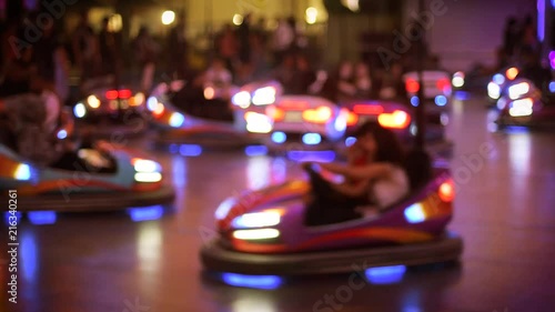 Defocused view of bumper car attraction nighttime view of funny atmosphere at the amusement park 4K UHD cinematic camera used