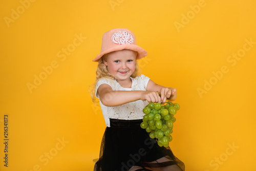 little girl with green wine grapes photo