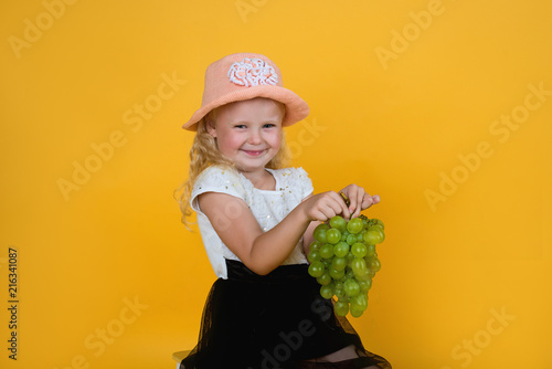 little girl with green wine grapes photo