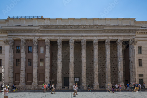 Tourists walking past Roman columns (part of the Temple of Hadrian) near Piazza della Minerva in Rome