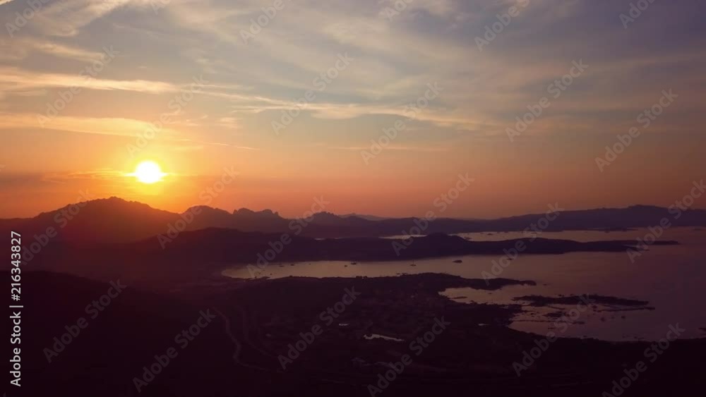 Video from above, aerial view of an amazing sunset behind some hills and a coast bathed by the Mediterranean Sea in Sardinia, Italy. Video from above, aerial view of an amazing sunset behind some hills and a coast bathed by the Mediterranean Sea in Sardinia, Italy.