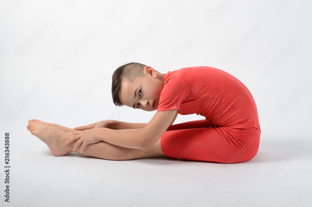 Male child gymnast stretching before competition Male child gymnast stretching before competition