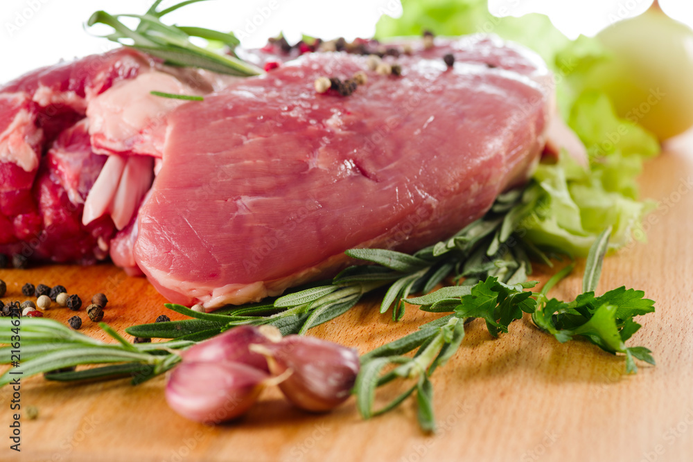 pork closeup on a board with salad and meat for cooking, selective focus