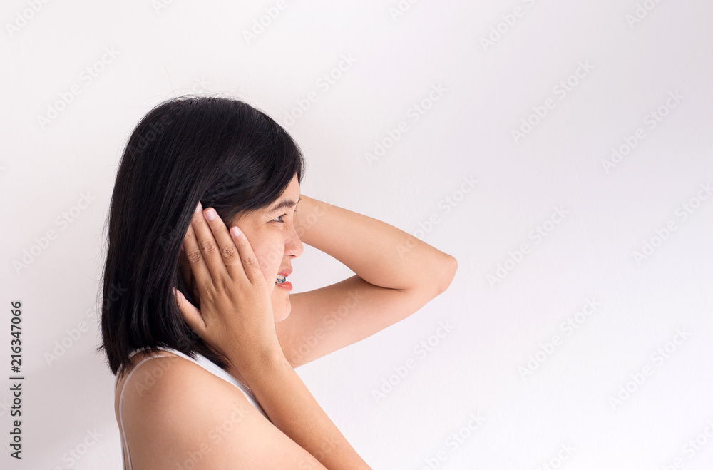 Asian woman on a white background holding her sick ear,Tinnitus Asian woman on a white background holding her sick ear,Tinnitus