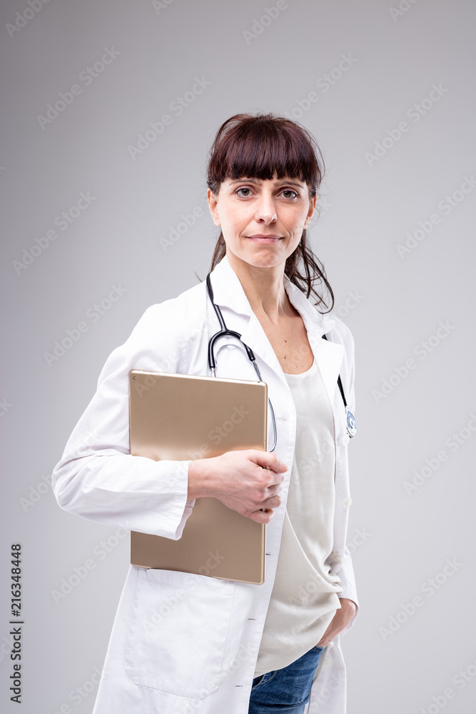 Busy female doctor pausing to look at the camera Busy female doctor pausing to look at the camera