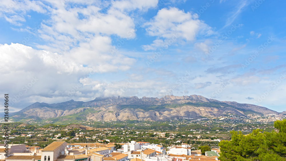 Spanish village surrounded by mountains with clouds. Traditional houses in the town of Altea on Costa Blanca, Spain.