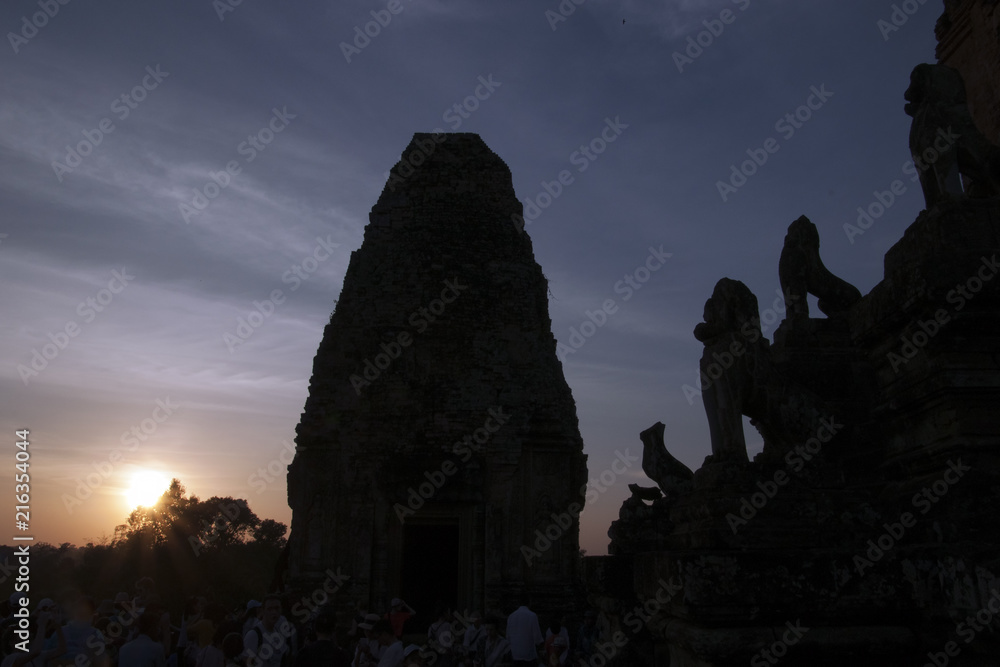 Angkor Cambodia, silhouette view of Pre Rup a 10th century hindu temple with stone animal statues on staircase at sunset