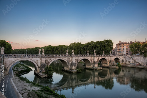 Pont St Angelo reflected in the Tiber river in Rome, Italy