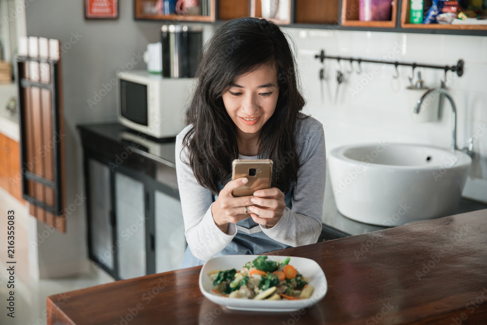 woman taking picture of food