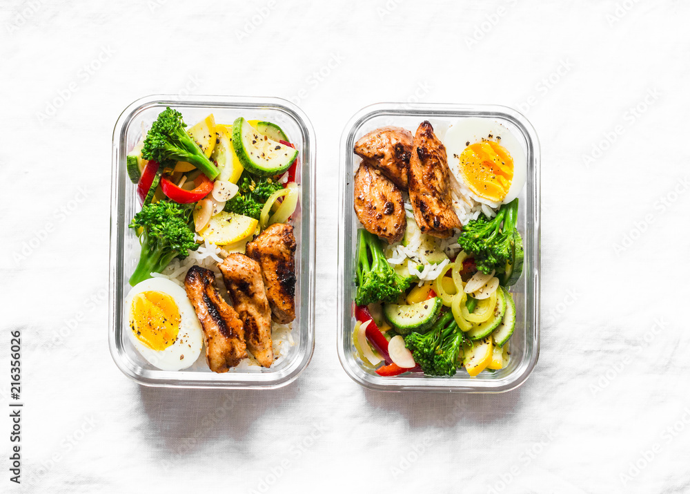 Rice, stewed vegetables, egg, teriyaki chicken - healthy balanced lunch box on a light background, top view. Home food for office concept. Copy space